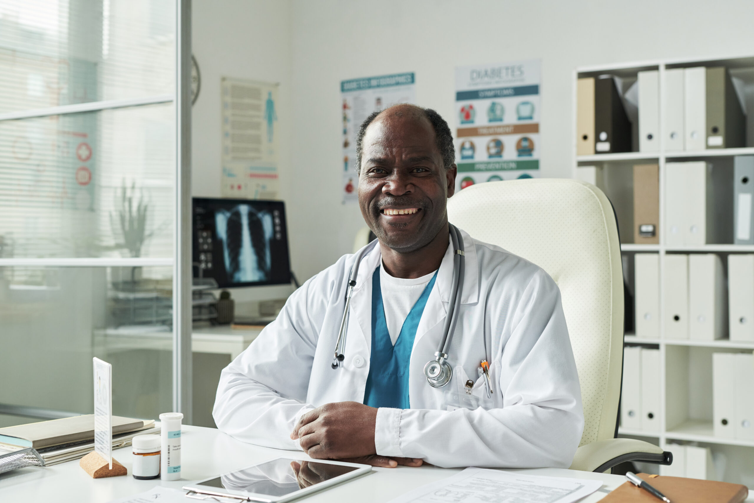 Portrait of Middle Aged Black Male Doctor Smiling during Diabetes Consultation